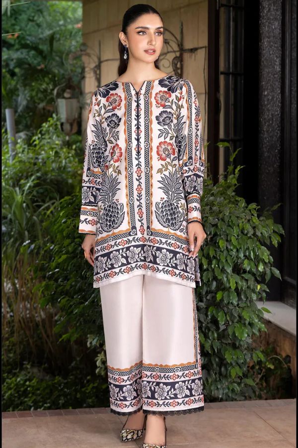 Woman wearing a traditional outfit with floral patterns outdoors.