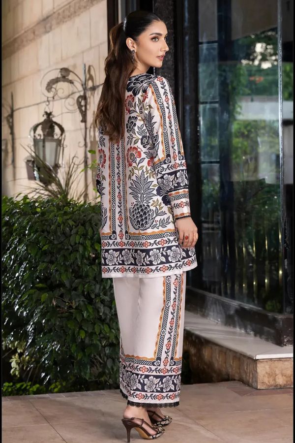 Woman wearing a patterned outfit standing outdoors.