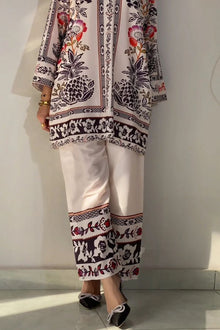 Traditional outfit with floral and geometric patterns on a plain background