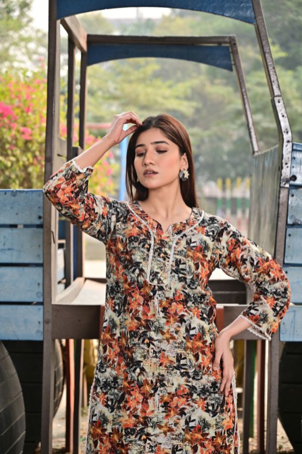 Woman wearing a floral dress standing outdoors with blurred background