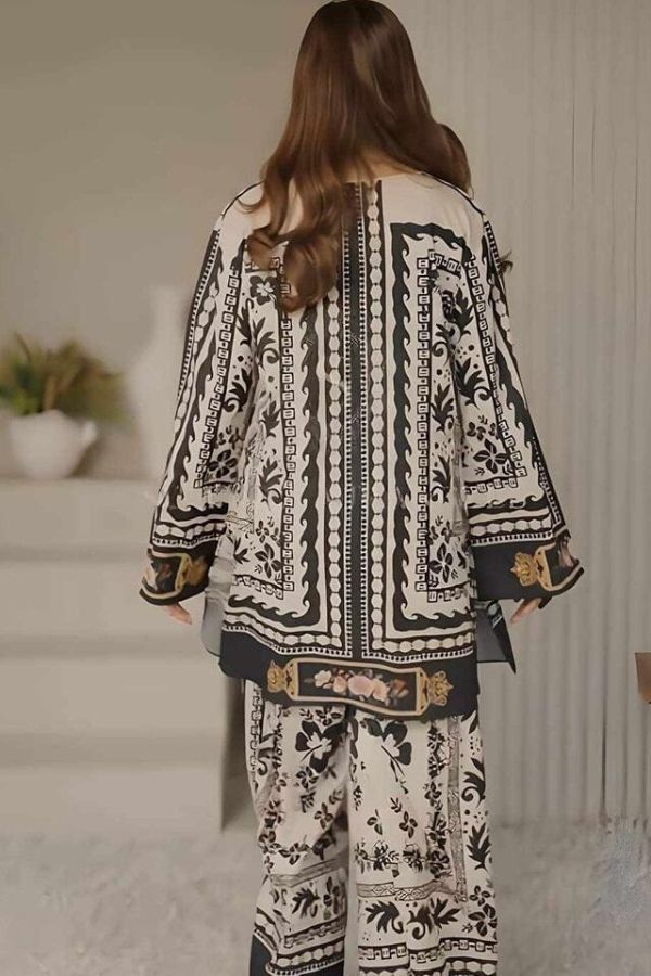 Person wearing a black and white patterned outfit in an indoor setting