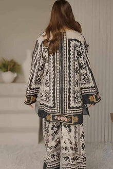 Person wearing a black and white patterned outfit in an indoor setting