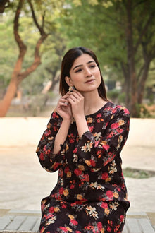 Woman wearing a floral dress in an outdoor setting