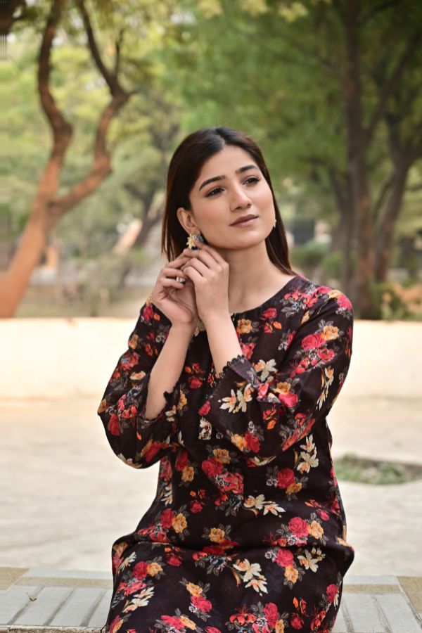 Woman wearing a floral dress in an outdoor setting