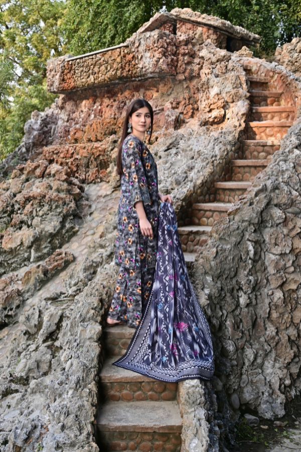 Woman in a floral dress standing on stone steps with a natural background