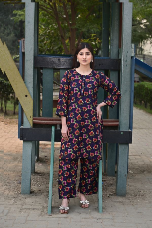 Woman in a floral dress standing on a playground structure