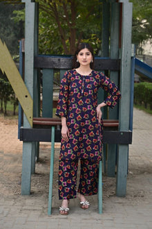 Woman in a floral dress standing on a playground structure