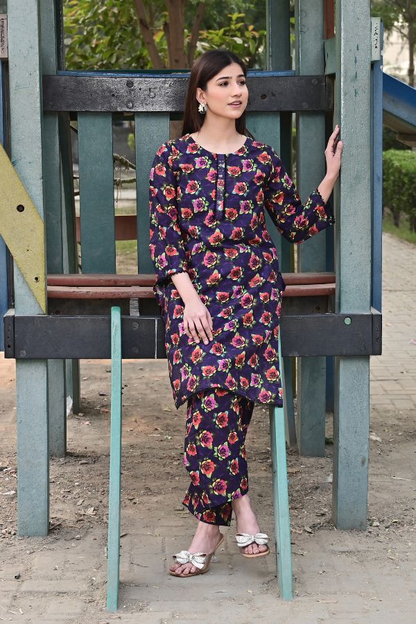 Woman in a floral dress standing on playground equipment